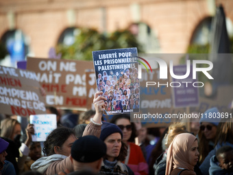 A protester holds a billboard reading 'Freedom for Palestinian women'. Women from the collective NousToutes and other organizations such as...