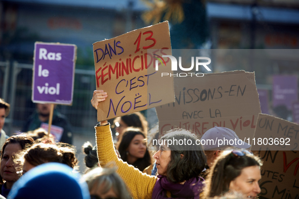 A woman holds a placard reading 'In 13 feminicides, it will be Christmas'. Women from the collective NousToutes and other organizations such...