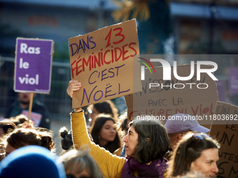 A woman holds a placard reading 'In 13 feminicides, it will be Christmas'. Women from the collective NousToutes and other organizations such...