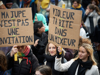 Placards read 'My skirt isn't an invitation' and 'Rapist your dick in a blender'. Women from the collective NousToutes and other organizatio...