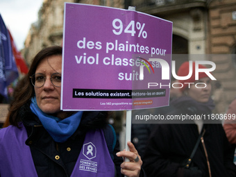 A woman holds a placard reading '94% of complaints for rape are dropped'. Women from the collective NousToutes and other organizations such...