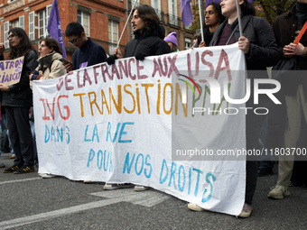 People hold a sheet reading 'From France to USA, Abortion, transition and ART, in the streets for our rights'. Women from the collective Nou...