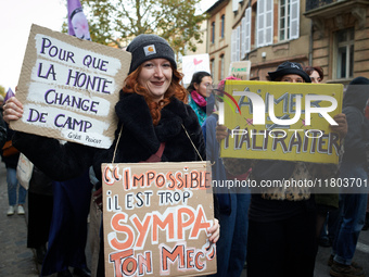 A woman holds a placard reading 'For shame to change sides' and 'Impossible:! Your friend is too kind'. The yellow placard reads 'Love isn't...