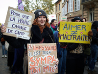 A woman holds a placard reading 'For shame to change sides' and 'Impossible:! Your friend is too kind'. The yellow placard reads 'Love isn't...