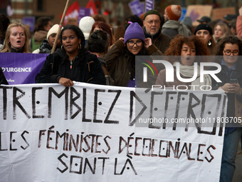 A group of women hold a sheet reading 'Tremble! The decolonial feminists are there'. Women from the collective NousToutes and other organiza...