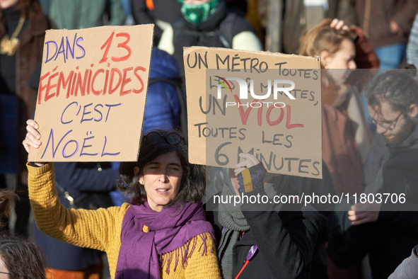 Two women hold placards reading 'in 13 feminicides it's Christmas' and 'A metro every 2 minutes, a rape every 6 minutes'. Women from the col...