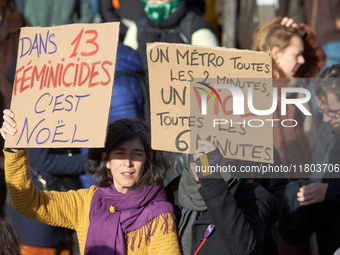 Two women hold placards reading 'in 13 feminicides it's Christmas' and 'A metro every 2 minutes, a rape every 6 minutes'. Women from the col...