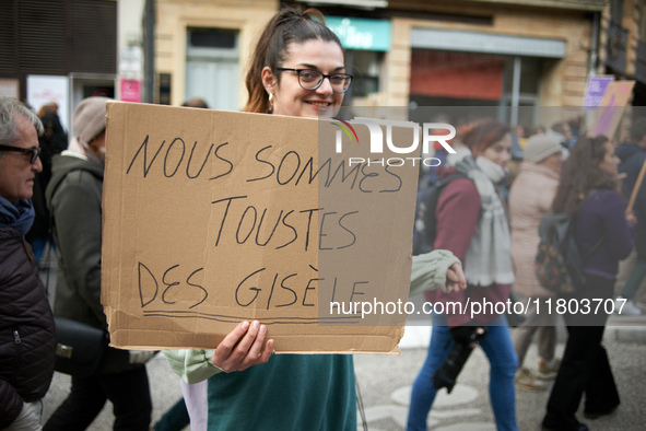 A woman holds a placard reading 'We are Gisele Pelicaud', a woman whose husband proposed to dozens of men while she was under the influence...