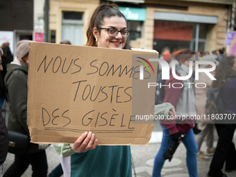 A woman holds a placard reading 'We are Gisele Pelicaud', a woman whose husband proposed to dozens of men while she was under the influence...