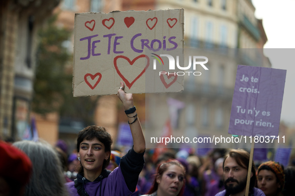 A protester holds a cardboard sign reading 'I believe you'. Women from the collective NousToutes and other organizations such as SUD or Amne...