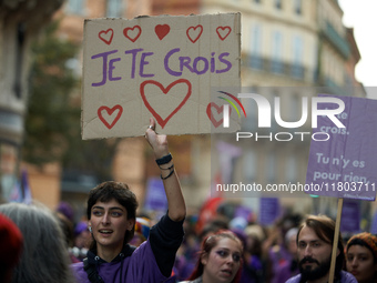 A protester holds a cardboard sign reading 'I believe you'. Women from the collective NousToutes and other organizations such as SUD or Amne...