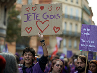 A protester holds a cardboard sign reading 'I believe you'. Women from the collective NousToutes and other organizations such as SUD or Amne...