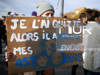 A woman holds a cardboard sign reading 'I quit him and he took my three children 457 days'. Women from the collective NousToutes and other o...