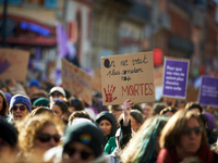 A woman holds a placard reading 'We don't want anymore to continue to count our dead'. Women from the collective NousToutes and other organi...