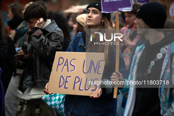 A woman holds a placard reading 'Not one more'. Women from the collective NousToutes and other organizations such as SUD and Amnesty Interna...