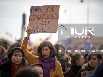 A woman displays a placard reading 'In 13 feminicides, it's Christmas'. Women from the collective NousToutes and other organizations such as...