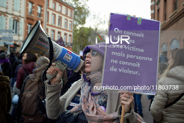 A protester holds a cardboard sign reading 'Everyone knows a victim but no one knows a rapist'. Women from the collective NousToutes and oth...