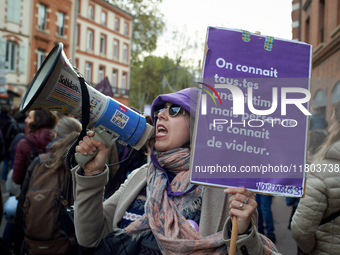 A protester holds a cardboard sign reading 'Everyone knows a victim but no one knows a rapist'. Women from the collective NousToutes and oth...