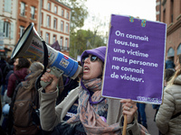 A protester holds a cardboard sign reading 'Everyone knows a victim but no one knows a rapist'. Women from the collective NousToutes and oth...