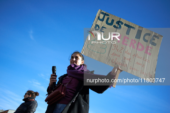 A woman holds a cardboard sign reading 'Shit justice, 94% of all complaints filed for rape are dropped'. Women from the collective NousToute...