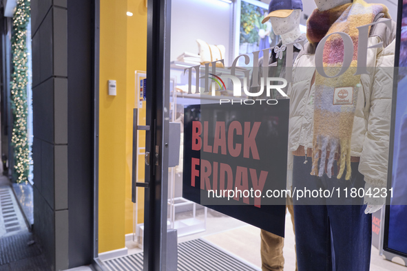 Promotional signage advertises up to 70% off for Black Friday at a clothing store in Bari, Italy, on November 24, 2024. The image highlights...