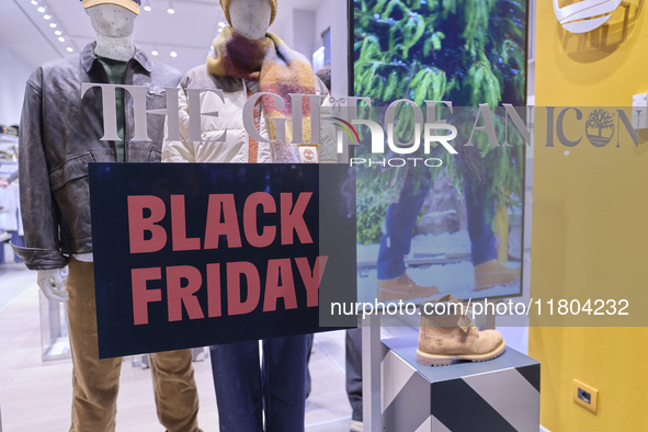 Promotional signage advertises up to 70% off for Black Friday at a clothing store in Bari, Italy, on November 24, 2024. The image highlights...