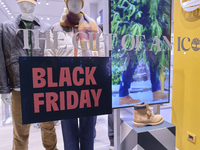 Promotional signage advertises up to 70% off for Black Friday at a clothing store in Bari, Italy, on November 24, 2024. The image highlights...