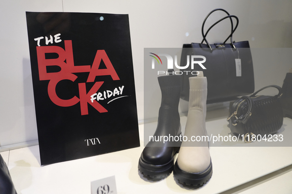 Promotional signage advertises up to 70% off for Black Friday at a clothing store in Bari, Italy, on November 24, 2024. The image highlights...