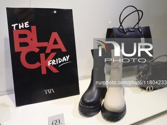 Promotional signage advertises up to 70% off for Black Friday at a clothing store in Bari, Italy, on November 24, 2024. The image highlights...