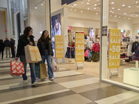 Promotional signage advertises up to 70% off for Black Friday at a clothing store in Foggia, Italy, on November 24, 2024. The image highligh...