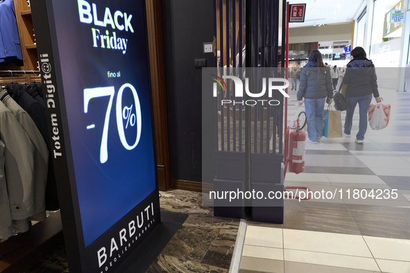 Promotional signage advertises up to 70% off for Black Friday at a clothing store in Foggia, Italy, on November 24, 2024. The image highligh...