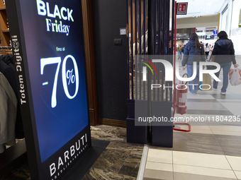 Promotional signage advertises up to 70% off for Black Friday at a clothing store in Foggia, Italy, on November 24, 2024. The image highligh...