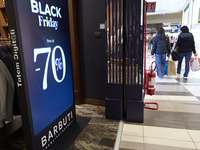 Promotional signage advertises up to 70% off for Black Friday at a clothing store in Foggia, Italy, on November 24, 2024. The image highligh...