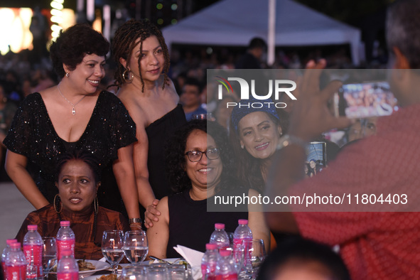 Sri Lanka's Prime Minister Harini Amarasuriya (center) and a group of women smile as they pose for a photograph at an ABBA tribute band Arri...