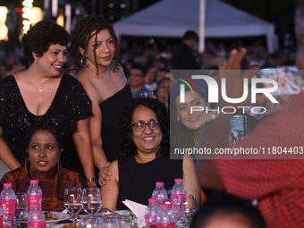 Sri Lanka's Prime Minister Harini Amarasuriya (center) and a group of women smile as they pose for a photograph at an ABBA tribute band Arri...