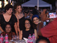 Sri Lanka's Prime Minister Harini Amarasuriya (center) and a group of women smile as they pose for a photograph at an ABBA tribute band Arri...