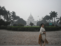 A woman walks inside a park on a foggy winter morning in Kolkata, India, on November 24, 2024. (