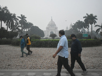 People walk inside a park on a foggy winter morning in Kolkata, India, on November 24, 2024. (