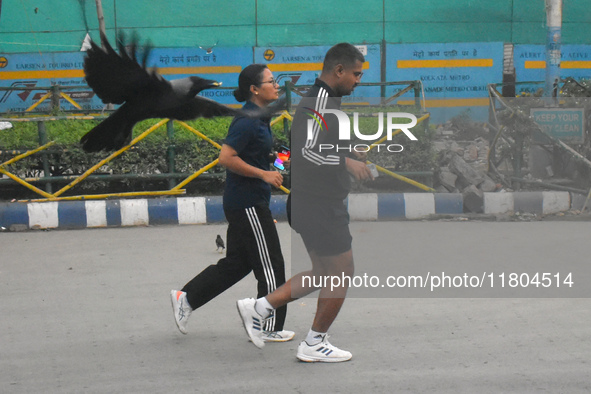 People run on the street in Kolkata, India, on November 24, 2024. 