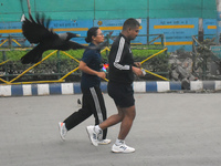 People run on the street in Kolkata, India, on November 24, 2024. (