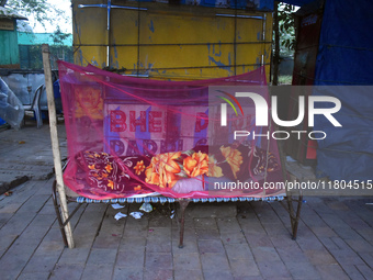 A person sleeps beside the street on a winter morning in Kolkata, India, on November 24, 2024. (