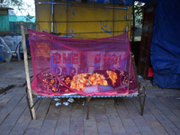 A person sleeps beside the street on a winter morning in Kolkata, India, on November 24, 2024. (