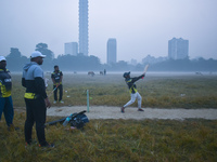 People play cricket inside a ground in Kolkata, India, on November 24, 2024. (