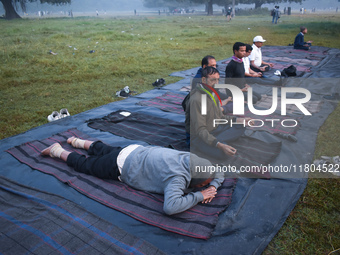 Old people perform yoga inside the ground on a foggy winter morning in Kolkata, India, on November 24, 2024. (