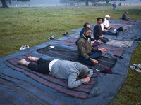 Old people perform yoga inside the ground on a foggy winter morning in Kolkata, India, on November 24, 2024. (