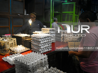 A person sells eggs inside a wholesale market in Kolkata, India, on November 24, 2024. (