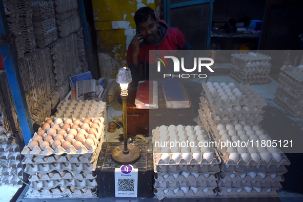 A vendor talks on his mobile while selling eggs inside a wholesale market in Kolkata, India, on November 24, 2024. 