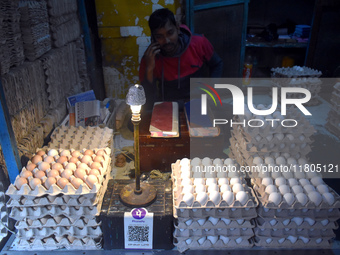 A vendor talks on his mobile while selling eggs inside a wholesale market in Kolkata, India, on November 24, 2024. (