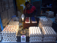 A vendor talks on his mobile while selling eggs inside a wholesale market in Kolkata, India, on November 24, 2024. (