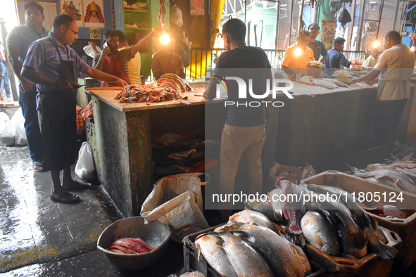 Vendors prepare fish inside a wholesale market in Kolkata, India, on November 24, 2024. 